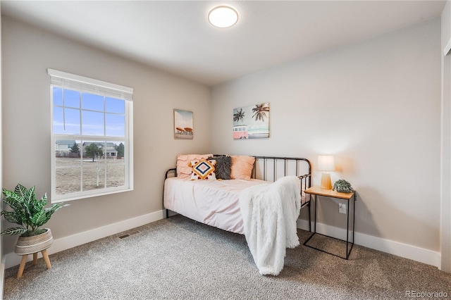 bedroom with carpet floors, visible vents, and baseboards