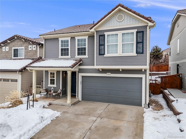 view of front of house with a tile roof, a porch, concrete driveway, fence, and a garage