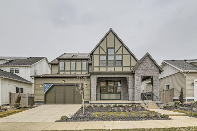 view of front of property with covered porch, solar panels, and a garage