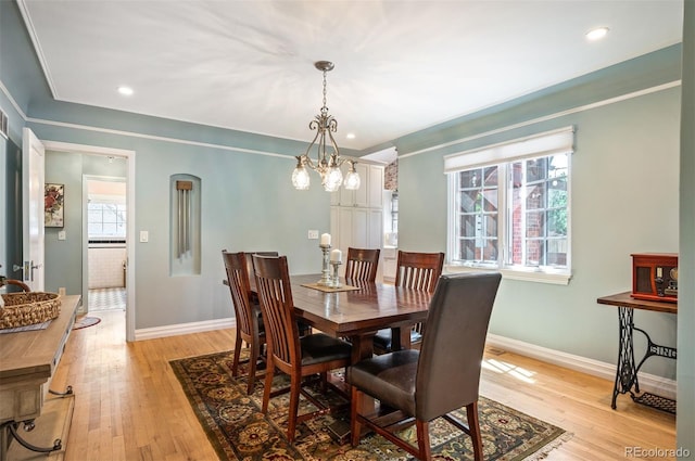 dining room with baseboards, light wood-style floors, a chandelier, recessed lighting, and arched walkways