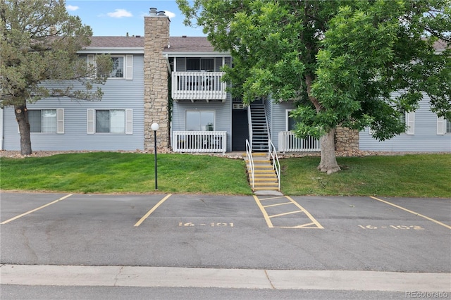 13404 E Jewell Ave Unit 101, Aurora, CO 80012 - view of property featuring stairway and uncovered parking