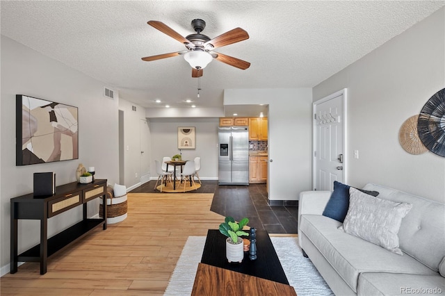 13404 E Jewell Ave Unit 101, Aurora, CO 80012 - living area with wood finished floors, a ceiling fan, a textured ceiling, and recessed lighting