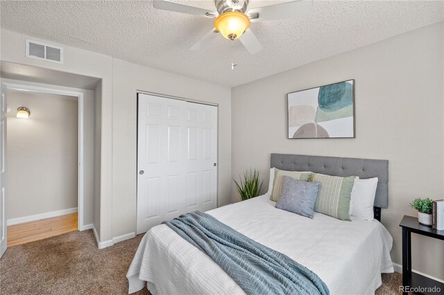 13404 E Jewell Ave Unit 101, Aurora, CO 80012 - bedroom featuring carpet, a closet, a ceiling fan, and a textured ceiling