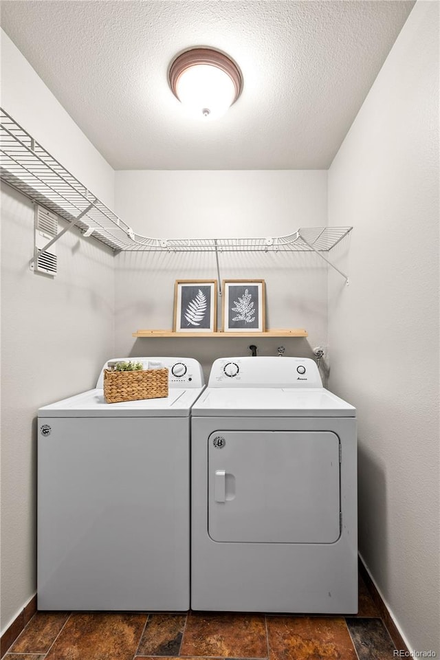 13404 E Jewell Ave Unit 101, Aurora, CO 80012 - laundry room featuring washer and clothes dryer and dark stone finish flooring