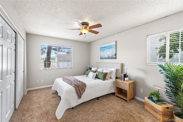 13404 E Jewell Ave Unit 101, Aurora, CO 80012 - bedroom featuring multiple windows, light colored carpet, a closet, a textured ceiling, and a ceiling fan