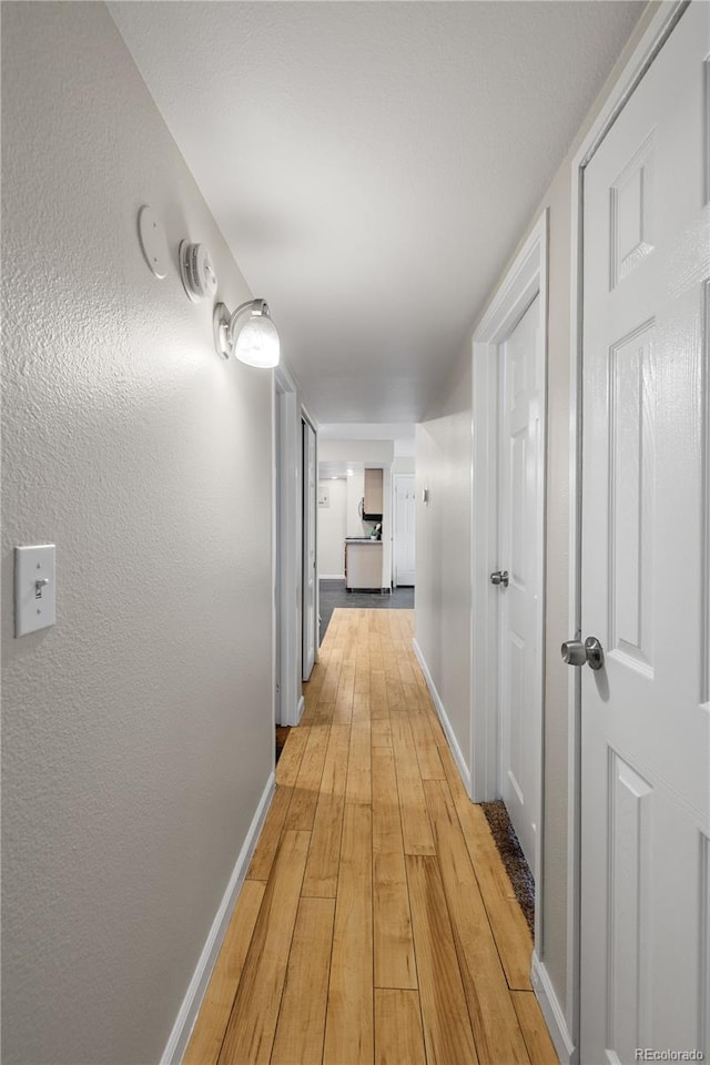 13404 E Jewell Ave Unit 101, Aurora, CO 80012 - hallway featuring light wood-style floors and baseboards