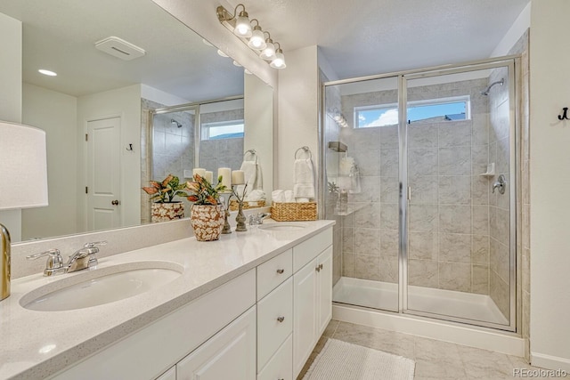 17396 Hop Clover Ave, Parker, CO 80134 - bathroom with double vanity, a shower stall, and tile patterned flooring