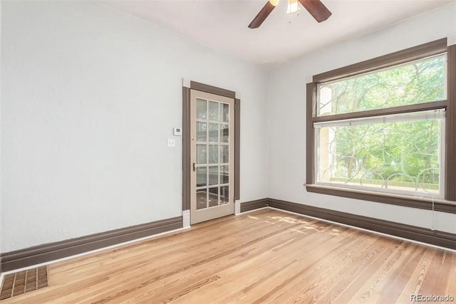 spare room with light hardwood / wood-style flooring and ceiling fan