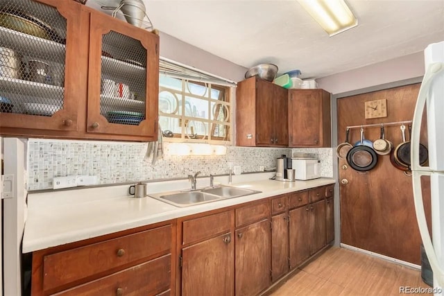 kitchen with decorative backsplash, sink, and white appliances