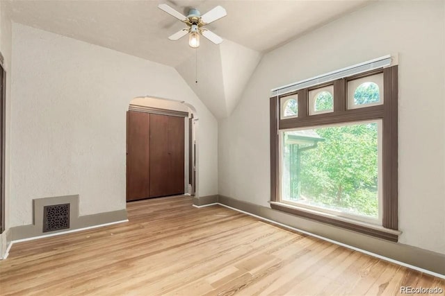 additional living space featuring light hardwood / wood-style floors, ceiling fan, and lofted ceiling