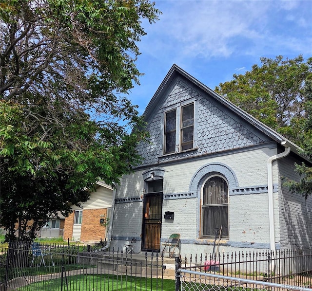 4316 Josephine St, Denver, CO 80216 - victorian house featuring a fenced front yard and brick siding