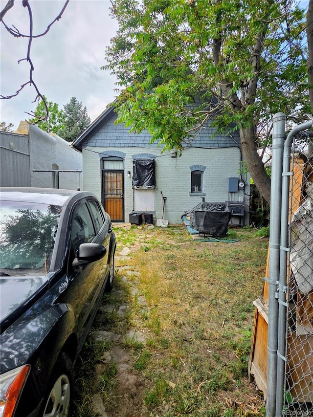 4316 Josephine St, Denver, CO 80216 - back of house featuring brick siding and a yard