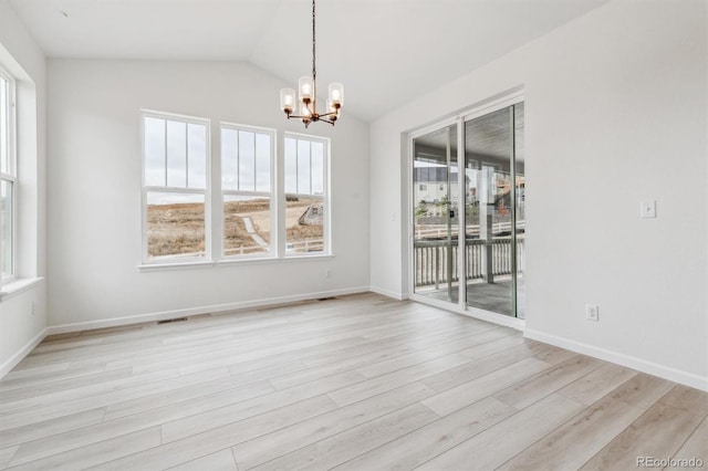 unfurnished dining area featuring vaulted ceiling, light hardwood / wood-style floors, and a chandelier