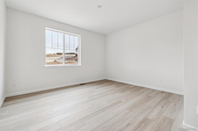 spare room with light wood-type flooring