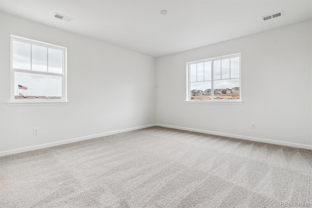 unfurnished room featuring carpet