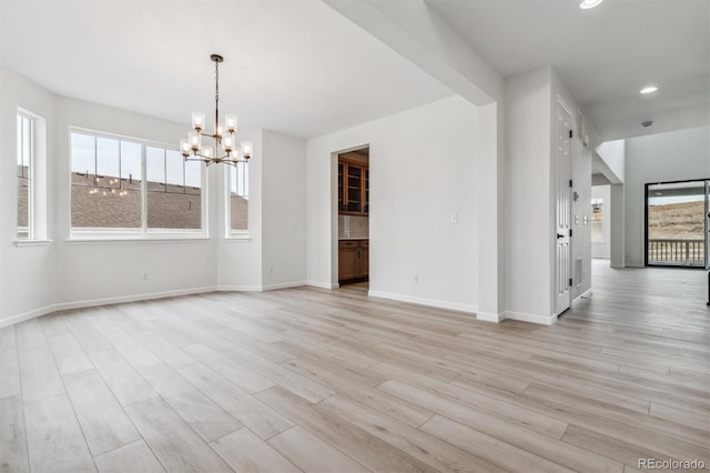 interior space with beamed ceiling, a notable chandelier, and light wood-type flooring