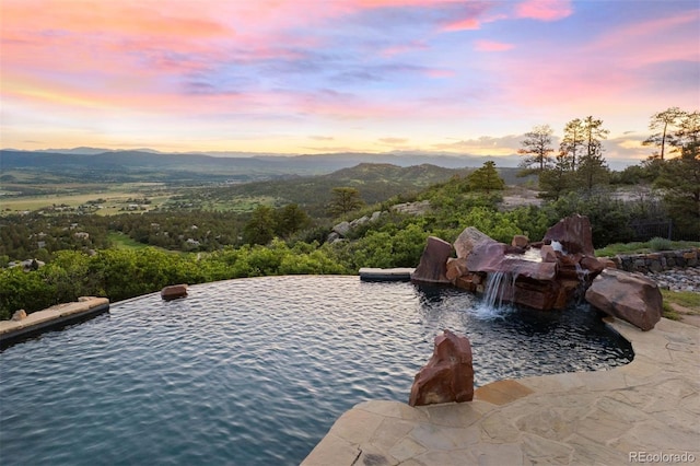 606 Cliffgate Ln, Castle Rock, CO 80108 - pool at dusk featuring a mountain view