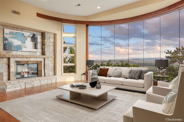 606 Cliffgate Ln, Castle Rock, CO 80108 - living area featuring wood finished floors, a stone fireplace, and recessed lighting