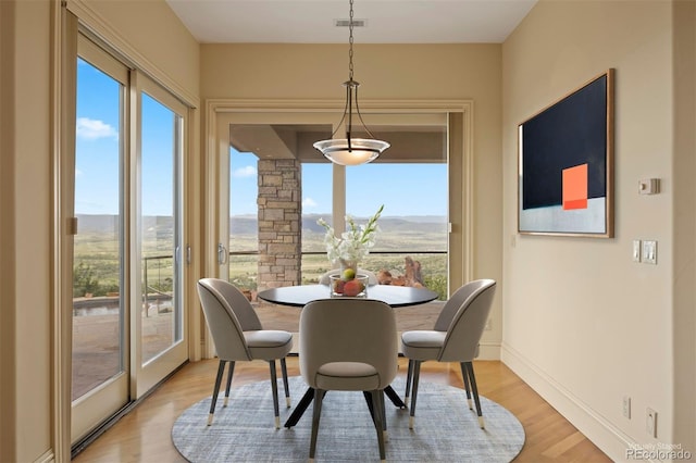 606 Cliffgate Ln, Castle Rock, CO 80108 - dining space with light wood-style flooring and a mountain view