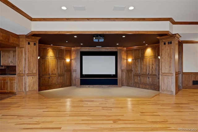 606 Cliffgate Ln, Castle Rock, CO 80108 - home theater with light wood-style flooring, crown molding, recessed lighting, and a decorative wall