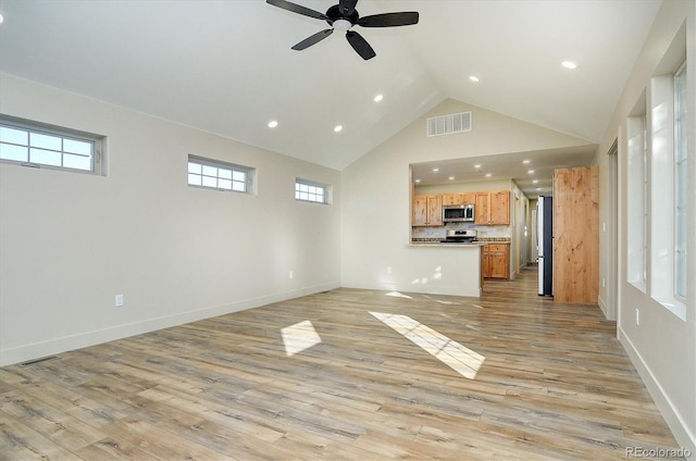 unfurnished living room with high vaulted ceiling, light hardwood / wood-style floors, and ceiling fan