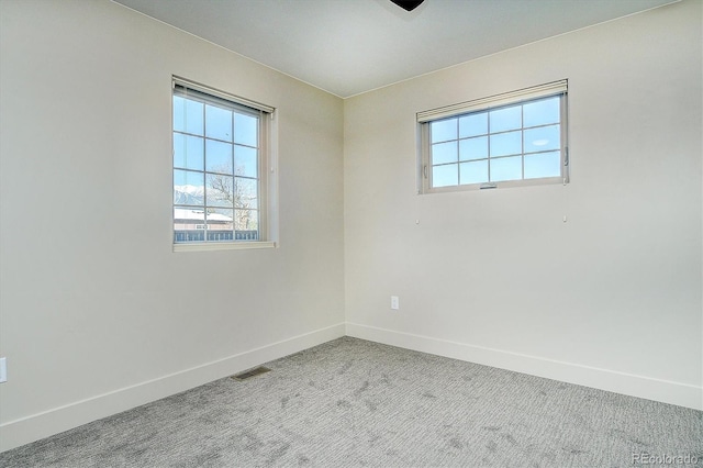 unfurnished room with light colored carpet