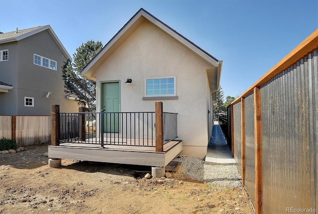 back of house featuring a deck