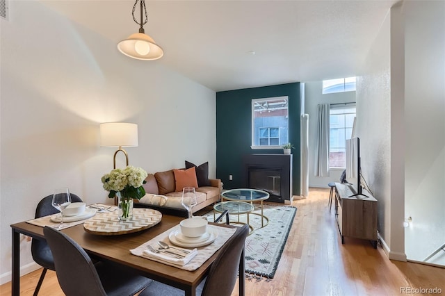 85 Uinta Way Unit 702, Denver, CO 80230 - living area featuring light wood-style floors, a glass covered fireplace, and baseboards