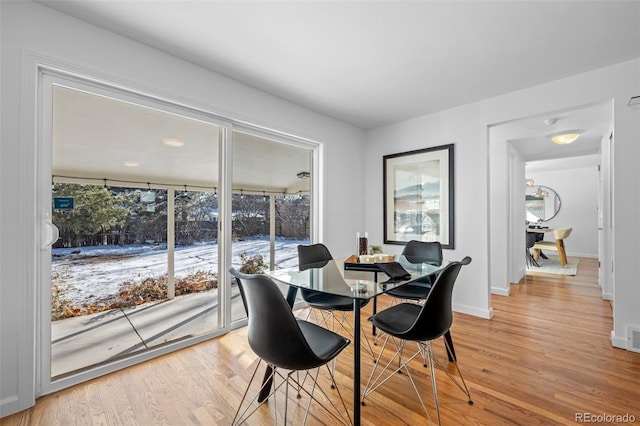 dining space with light hardwood / wood-style floors