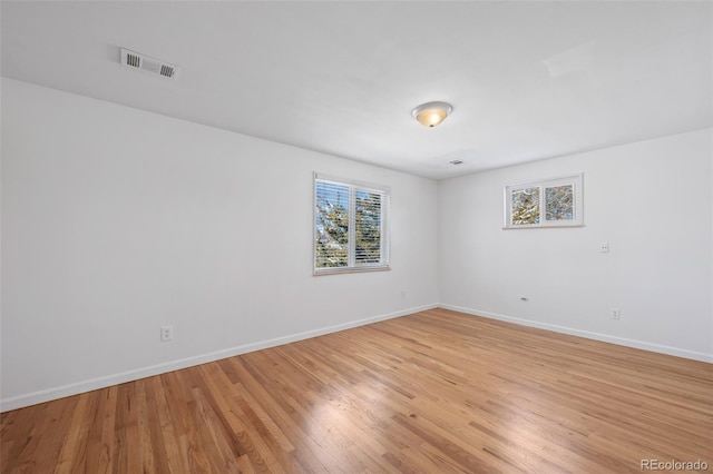 unfurnished room with light wood-type flooring