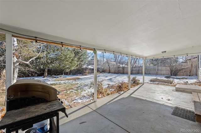 snow covered patio with grilling area