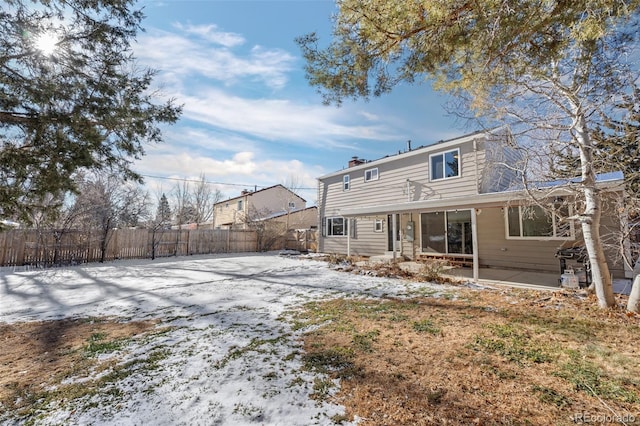 snow covered house with a patio