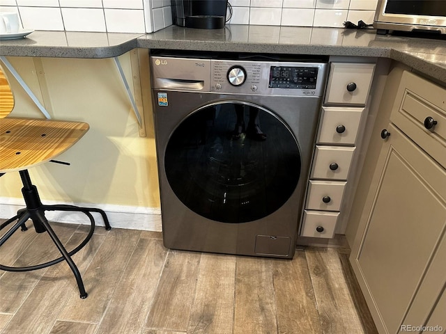 1301 N Ogden St Unit 1A, Denver, CO 80218 - laundry room featuring washer / dryer and wood finished floors