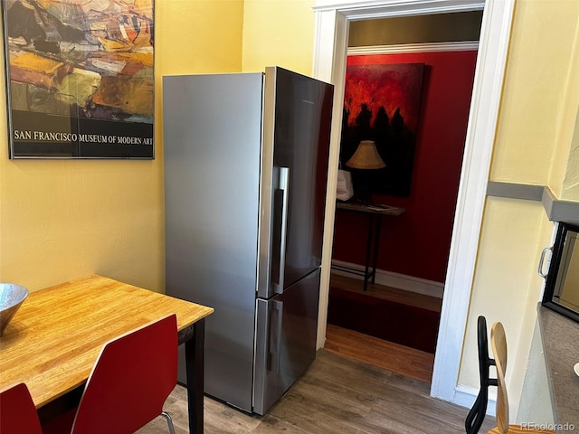 1301 N Ogden St Unit 1A, Denver, CO 80218 - kitchen with freestanding refrigerator and wood finished floors