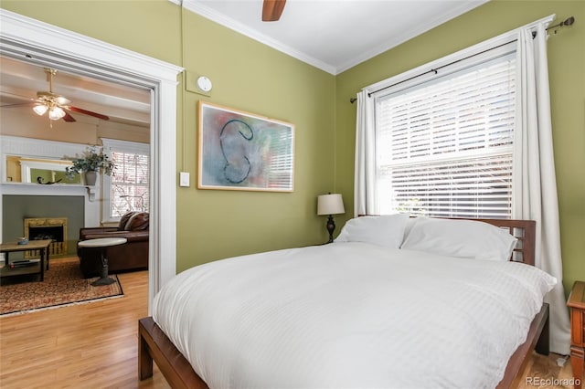 1301 N Ogden St Unit 1A, Denver, CO 80218 - bedroom featuring wood finished floors, ornamental molding, a fireplace, and ceiling fan