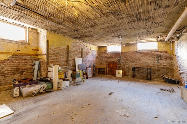 1301 N Ogden St Unit 1A, Denver, CO 80218 - misc room with brick wall and hardwood / wood-style flooring