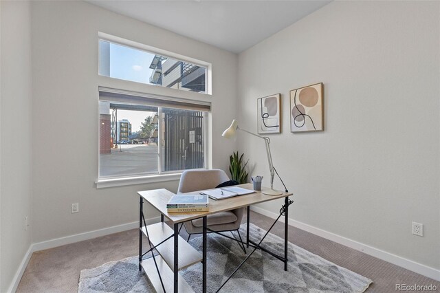 carpeted office featuring baseboards