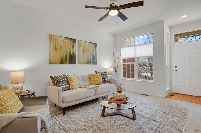 living room with recessed lighting, visible vents, ceiling fan, and baseboards