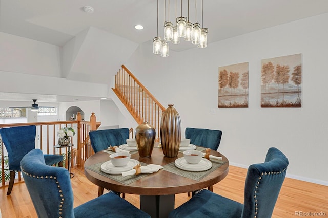 dining room with light wood-style floors, recessed lighting, baseboards, and ceiling fan with notable chandelier