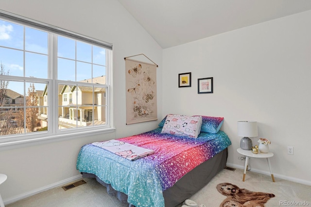 carpeted bedroom with lofted ceiling, visible vents, and baseboards