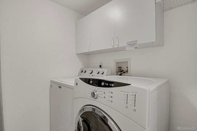 laundry area featuring independent washer and dryer and cabinet space