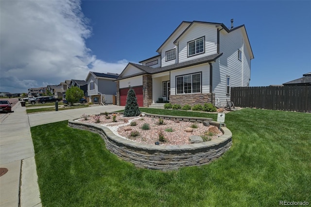 9455 Shinnecock Ct, Peyton, CO 80831 - view of front of house with concrete driveway, stone siding, and an attached garage