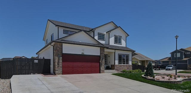9455 Shinnecock Ct, Peyton, CO 80831 - view of front of house featuring stone siding, concrete driveway, an attached garage, and roof with shingles