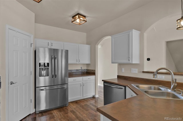 9455 Shinnecock Ct, Peyton, CO 80831 - kitchen featuring stainless steel appliances, a sink, dark countertops, and dark wood-type flooring