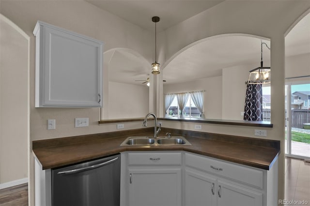 9455 Shinnecock Ct, Peyton, CO 80831 - kitchen featuring dishwasher, dark countertops, a sink, arched walkways, and ceiling fan
