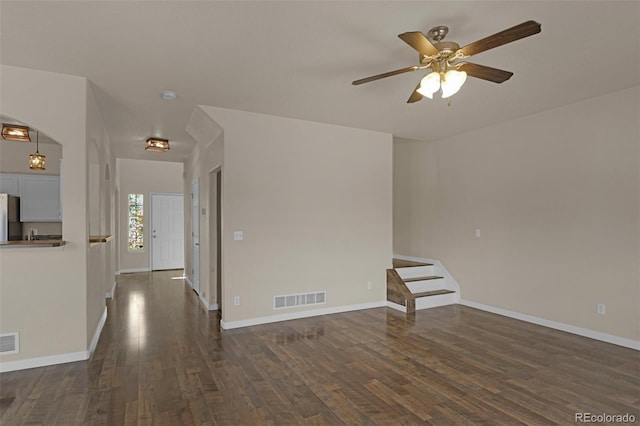9455 Shinnecock Ct, Peyton, CO 80831 - unfurnished room with dark wood-style flooring, a ceiling fan, and baseboards