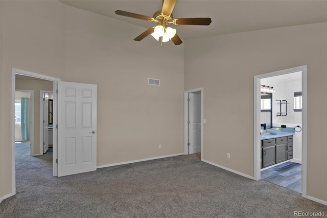 9455 Shinnecock Ct, Peyton, CO 80831 - unfurnished bedroom featuring carpet flooring, high vaulted ceiling, baseboards, ensuite bathroom, and a ceiling fan