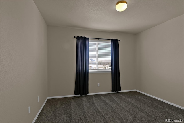 9455 Shinnecock Ct, Peyton, CO 80831 - spare room featuring dark colored carpet, baseboards, and a textured ceiling