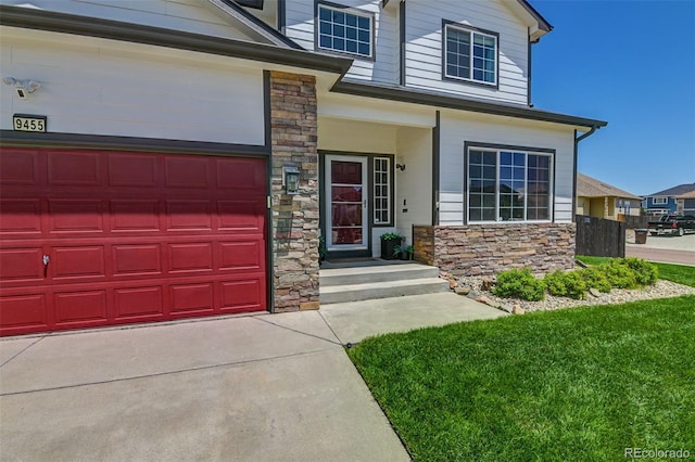 9455 Shinnecock Ct, Peyton, CO 80831 - view of front of home featuring stone siding, a garage, a front yard, and driveway