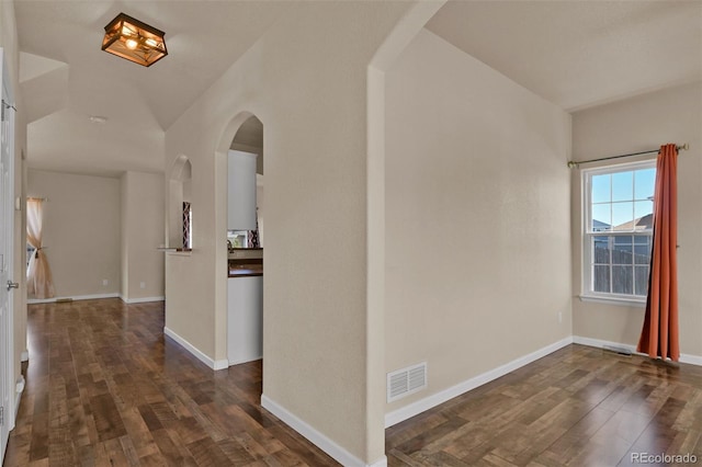 9455 Shinnecock Ct, Peyton, CO 80831 - entrance foyer with arched walkways, dark wood finished floors, and baseboards